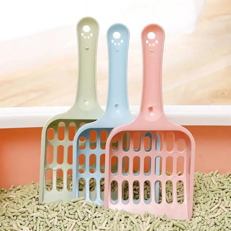 Blue plastic cat litter scoop on a white background