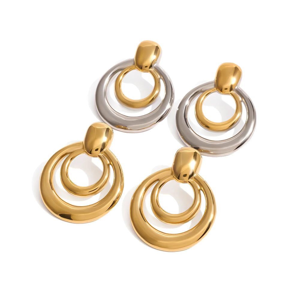 Round double layer hollow stud earrings with a gold electroplated finish on a titanium steel base.