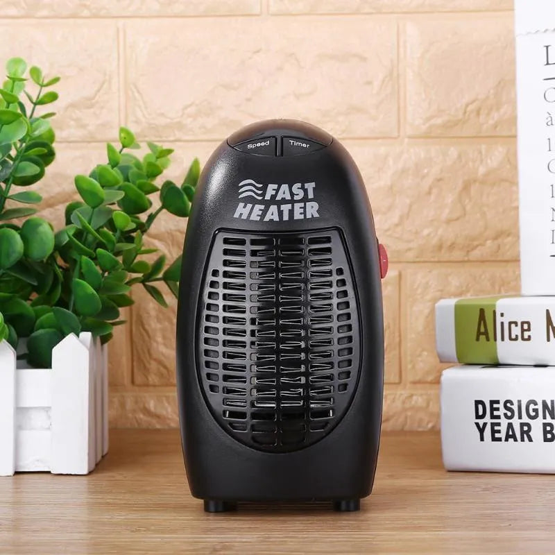 Black plastic mini electric heater with digital display and rotating plug on white background