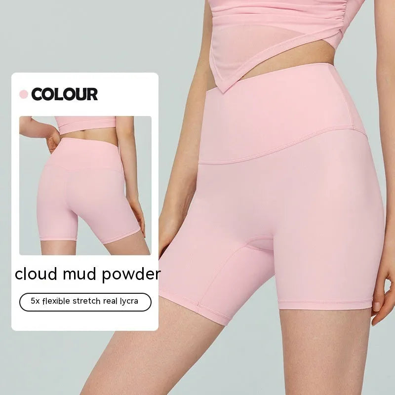 Women's high waist Lycra yoga shorts in leaf green, shown in a yoga pose.
