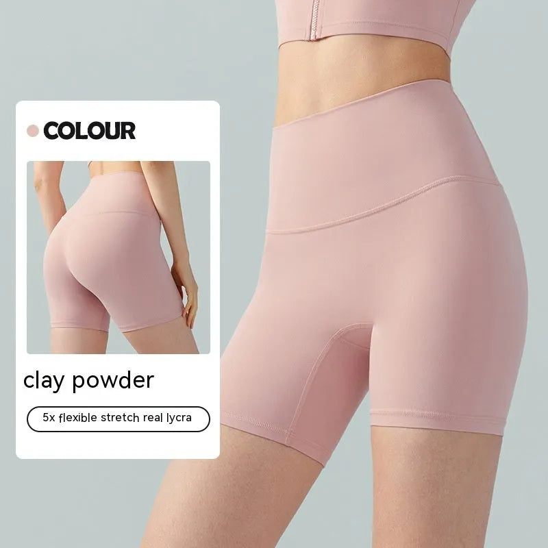 Women's high waist Lycra yoga shorts in leaf green, shown in a yoga pose.