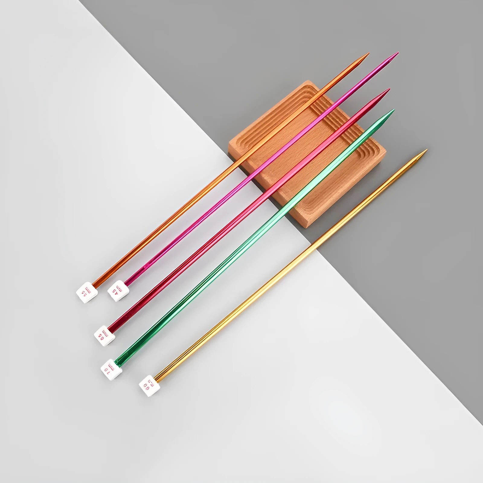 Set of crochet hooks in various sizes from 2.0mm to 10.0mm, each with a protective cap on a lengthened handle.