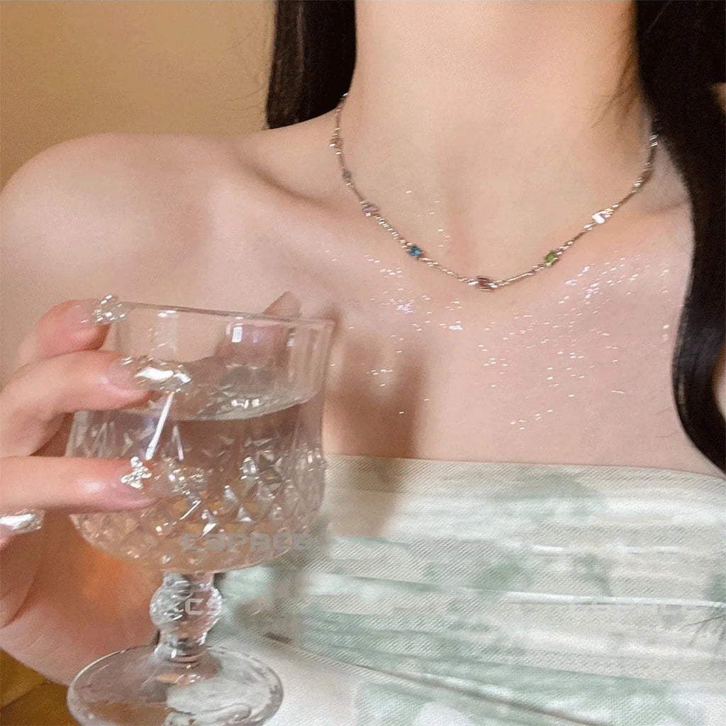 Square artificial crystal pendant on a fine gold clavicle chain necklace.