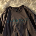Loose fit black pure cotton short sleeve t-shirt with a letter pattern on a hanger.