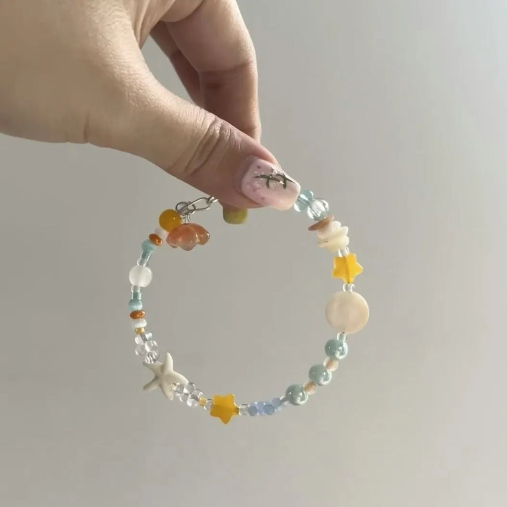 Orange mixed material women's bracelet with diamond shape and round seaside elements