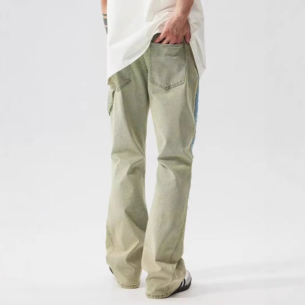 Yellow and blue retro patchwork distressed jeans on a model