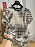 Men's black and white striped short sleeve linen shirt with loose fit pullover style displayed on flat lay