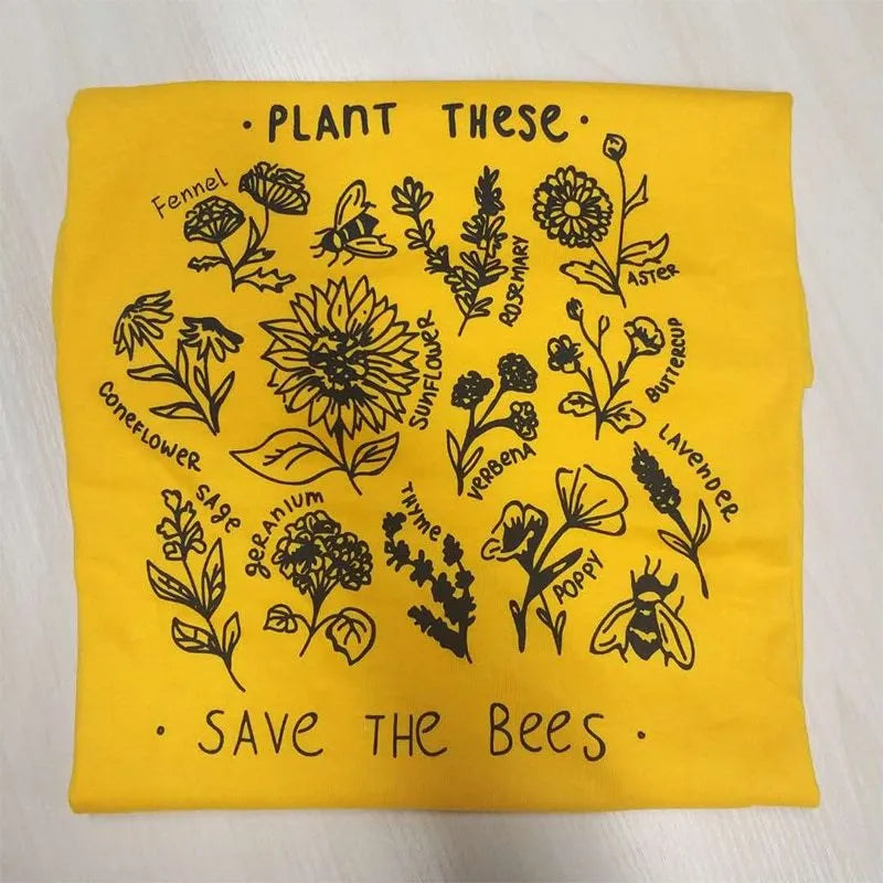 Woman wearing a white cotton Save The Bees t-shirt with a cartoon natural scenery print