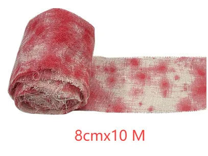 Roll of Halloween horror dyed gauze bandage in bloody red colour, shown with a loose end draped.