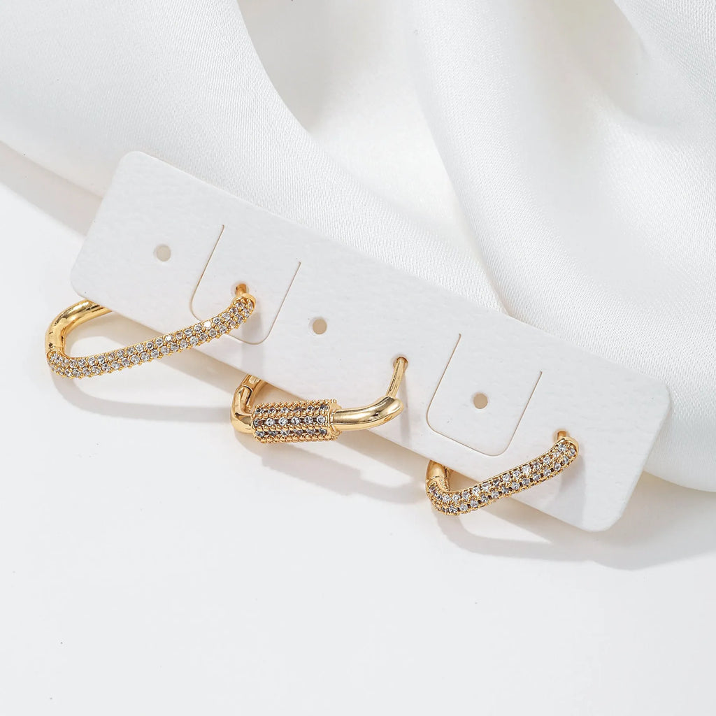 Three geometric copper ear clips with micro inlaid zircon treatment in gold and white colours