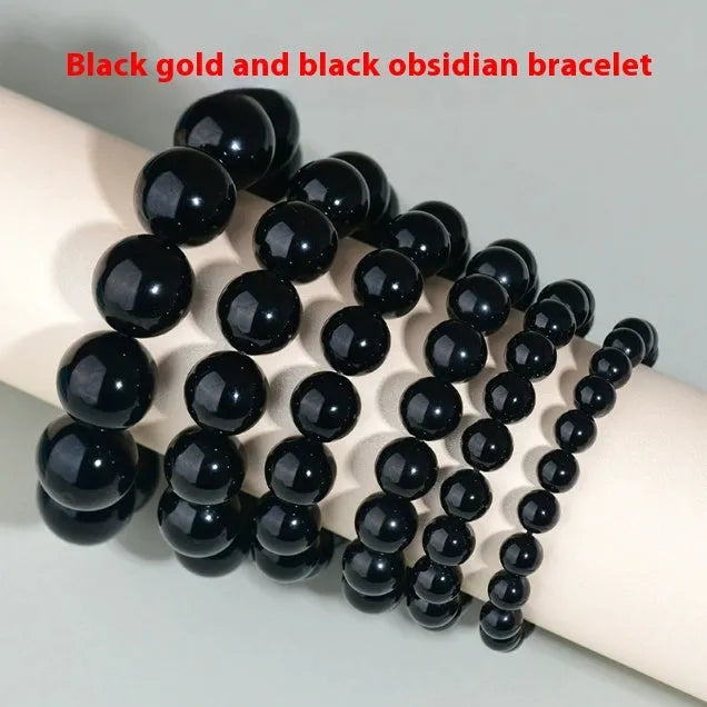 Hand-woven obsidian bracelet with round beads and engraved birth year detail for couples