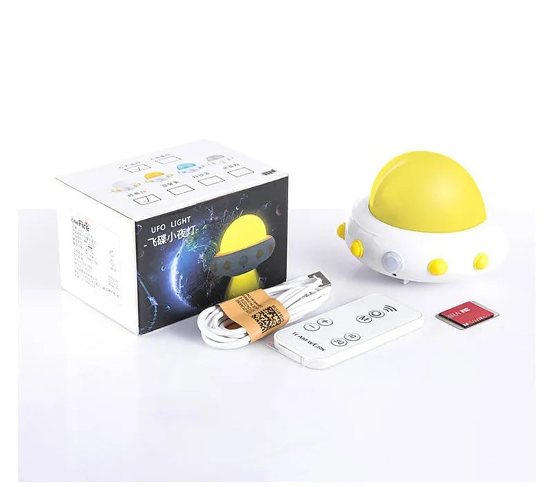 Blue UFO-shaped bedside night light with remote control on a table.