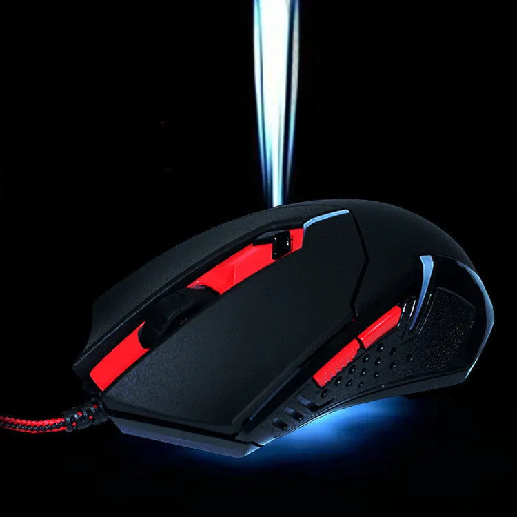Black and red wired USB gaming mouse with six buttons and scroll wheel on a desk.