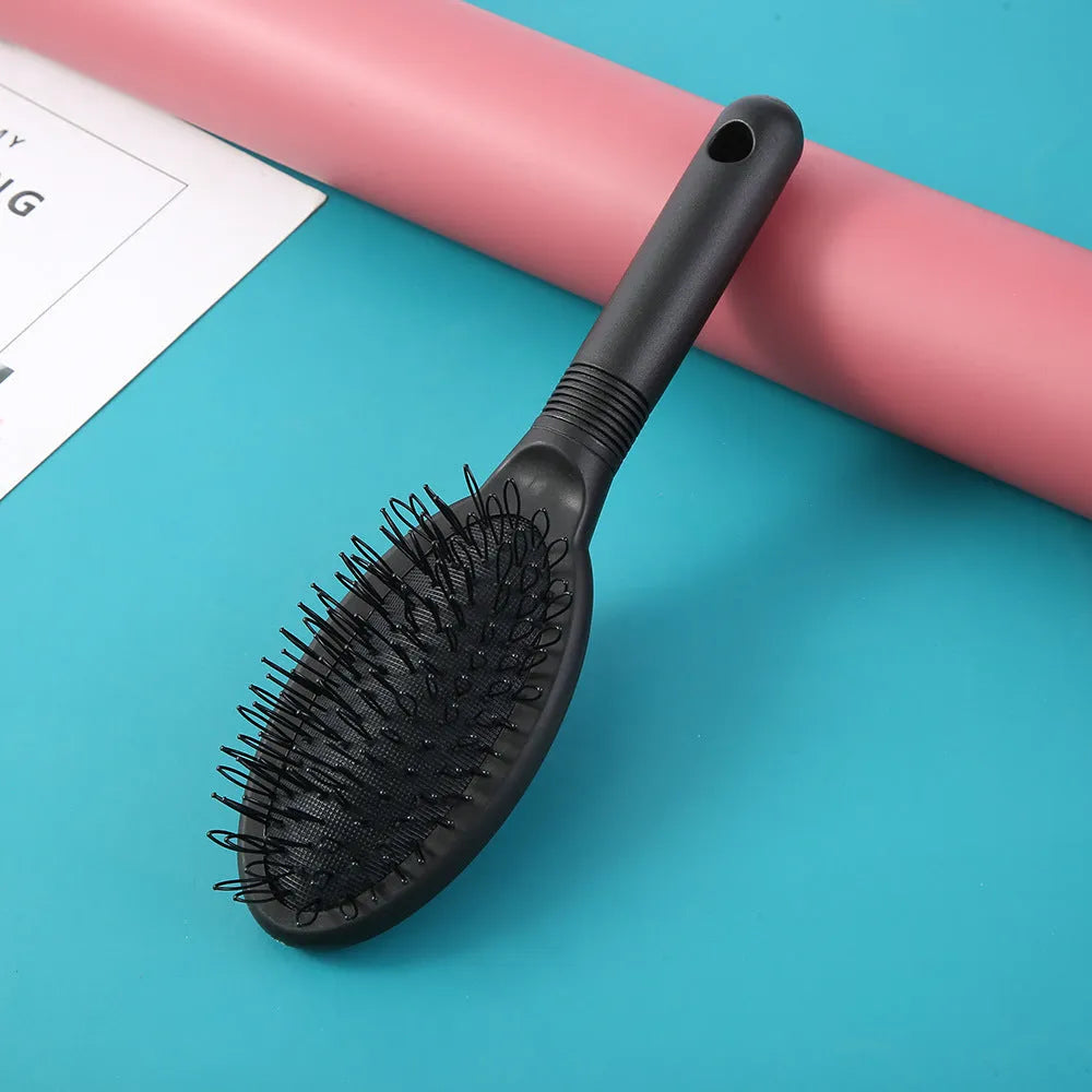 Ring tooth hair extension comb with airbag design measuring 22cm by 6cm in black or pink ABS plastic