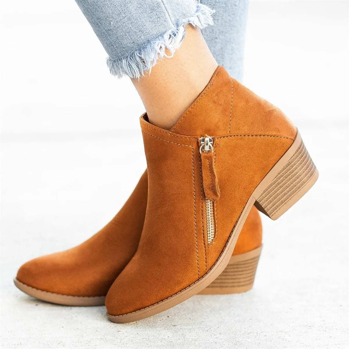Women's suede ankle boots with side zip and chunky heel in beige, black, blue, or orange.