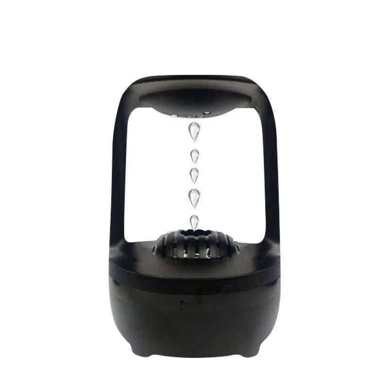 White anti-gravity humidifier with water droplet effect on a desk next to a USB cable.