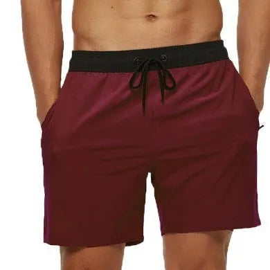 Men's blue drawstring athletic shorts with a zipper pocket and stitching detail on the waistband