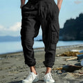 Men's solid colour linen casual trousers with ankle-tied cuffs, multiple pockets, and a drawstring waist