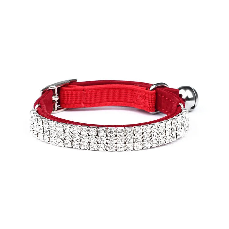 Adjustable velvet cat collar with rhinestones on a black background showing red, blue, and purple colour options.