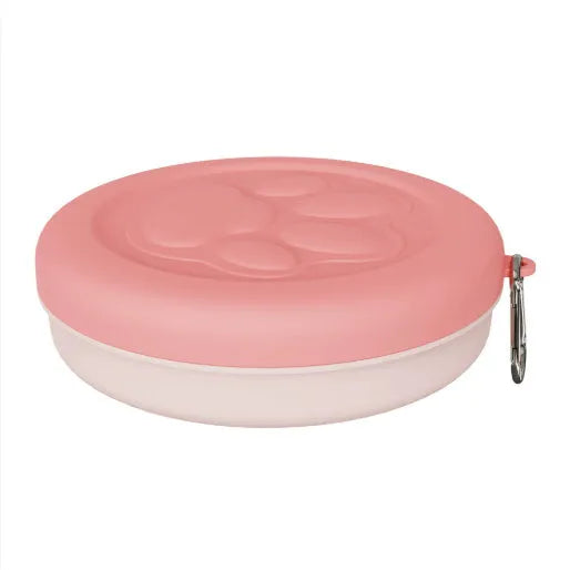 Portable outdoor dog food and water bowl with attached snack box in light pink and green colours.