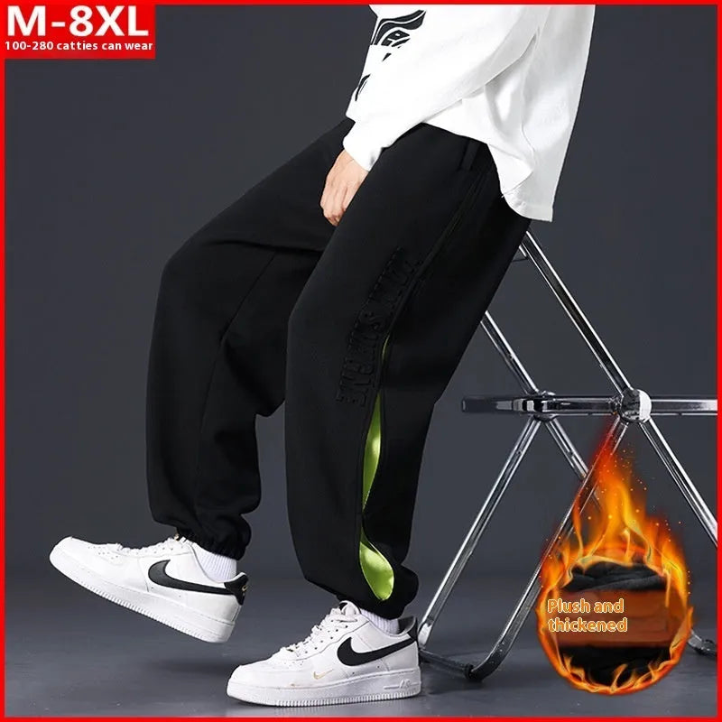 Men's loose fit cotton trousers with banded ankles and stitching details in grey green colour