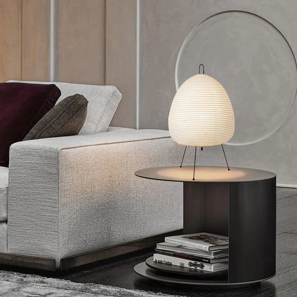 Japanese style rice paper table lamp with aluminium body and decorative shade on wooden surface