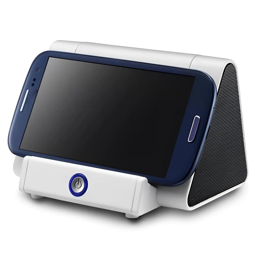 Small black and white wireless Bluetooth speaker with built-in USB charging cable on a desk.