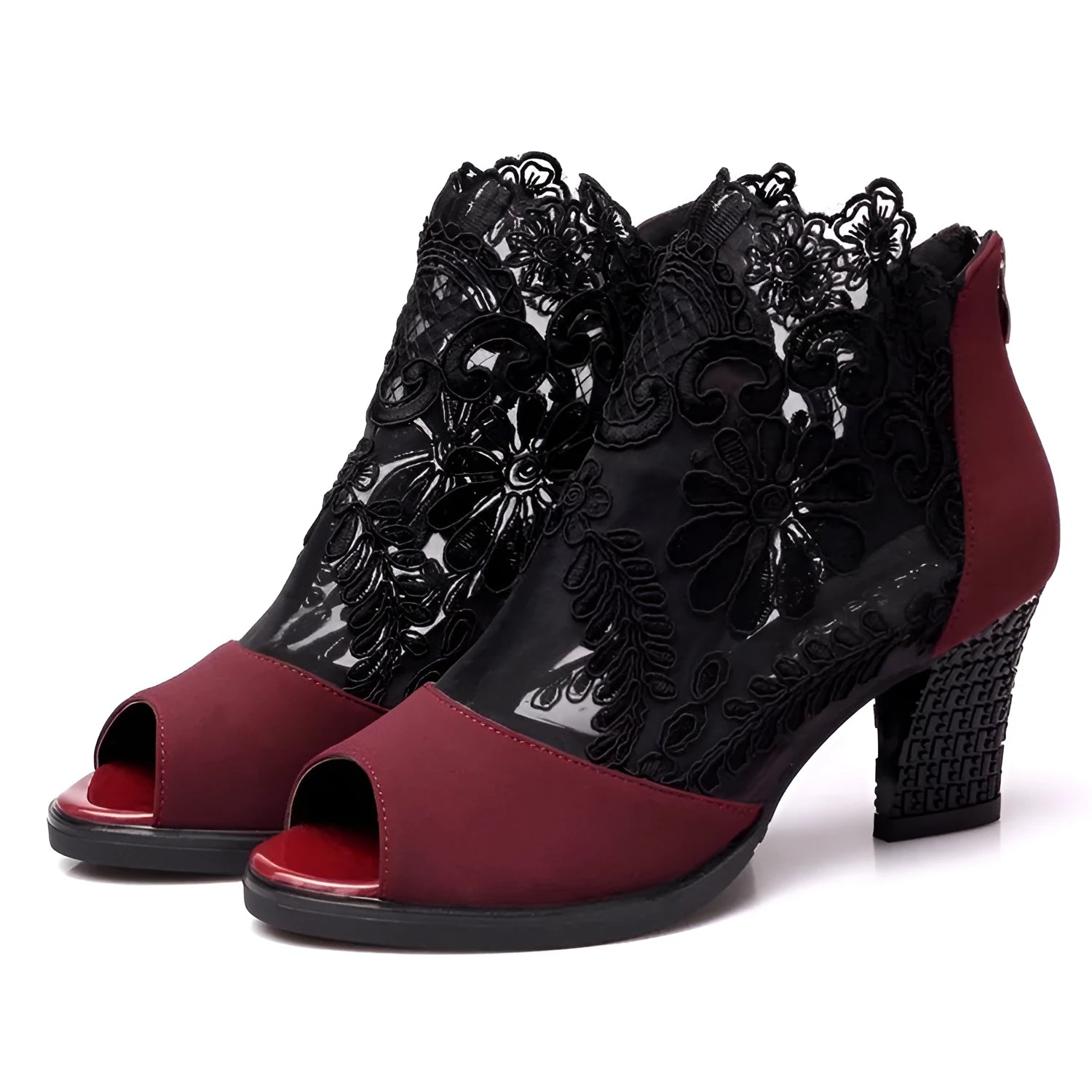 Black lace gladiator sandals with a square high heel and peep toe on a woman's foot