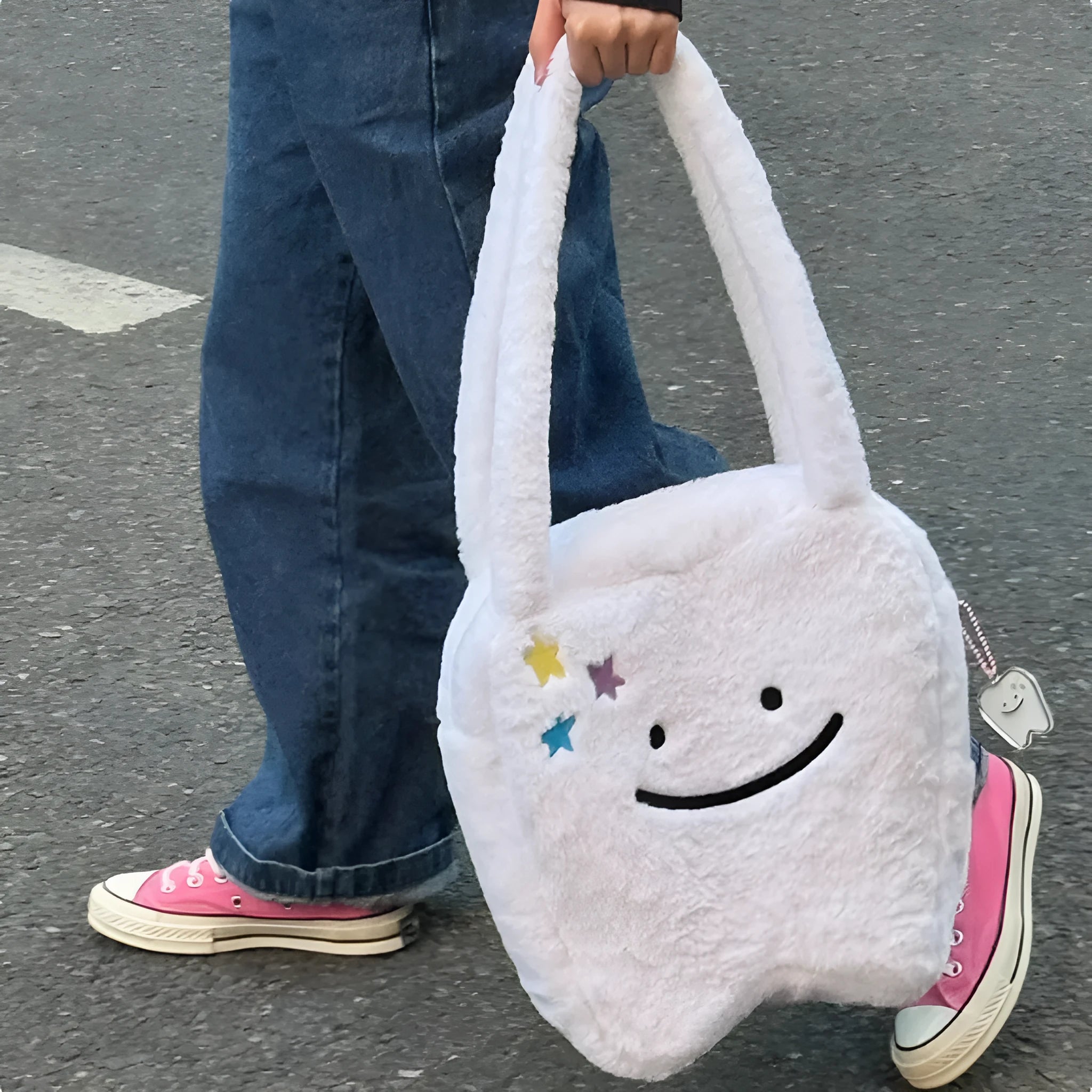 White shoulder tote bag with plush large tooth decorative detail and zip closure