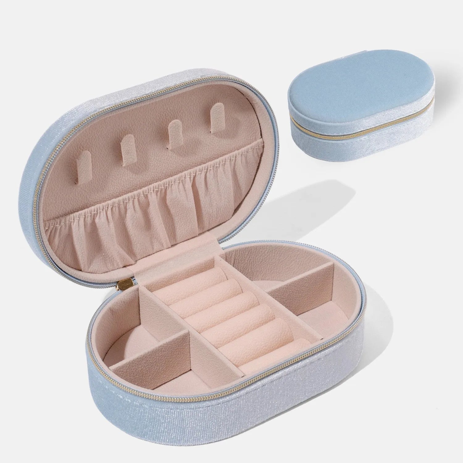 Oval velvet jewellery storage box in lake blue colour, showing flannel-lined interior and compact size.