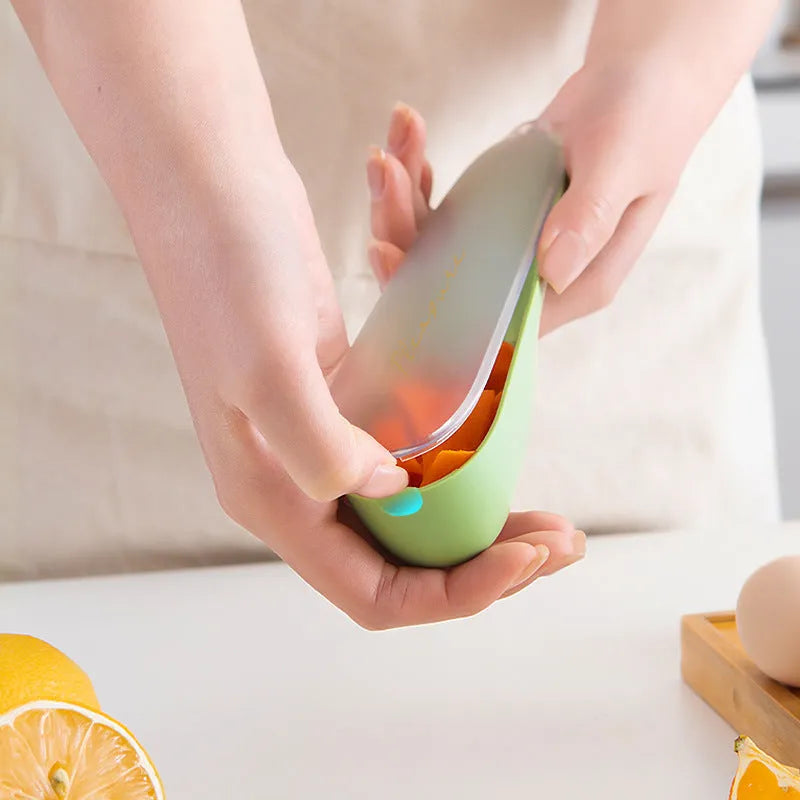 Green fruit and vegetable peeler with a storage tube and stainless steel blade.