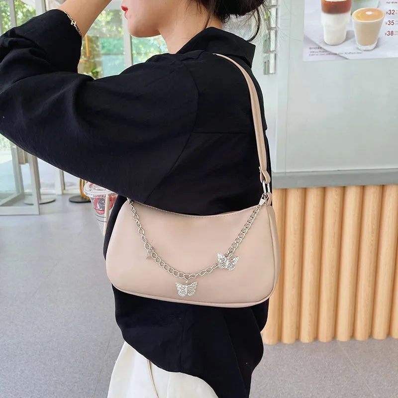 Women's black PU butterfly chain underarm handbag with crossbody strap, shown in a horizontal square shape.