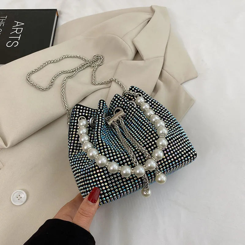 Women's soft PU light diamond decorated crossbody shoulder bag with chain strap in bucket shape.
