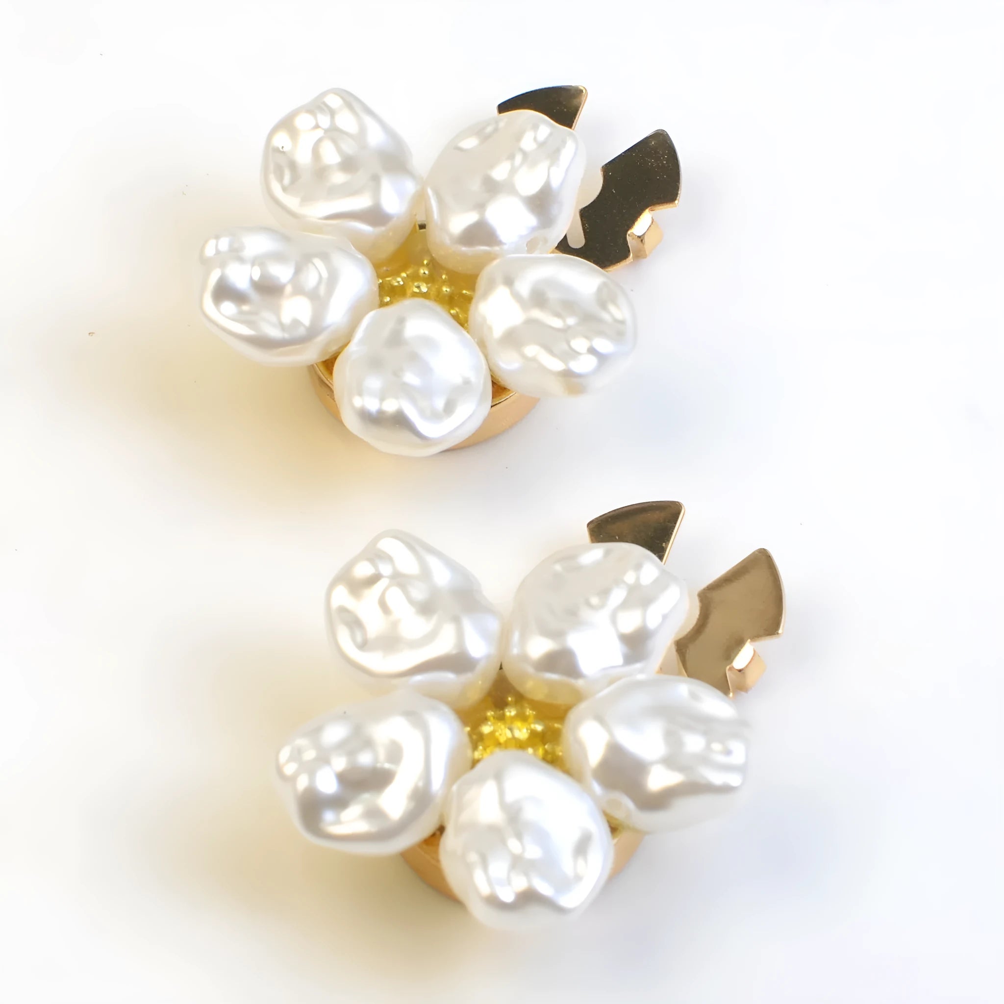 White alloy pearl rhinestone cufflink with electroplated finish and inlaid diamond setting on solid background
