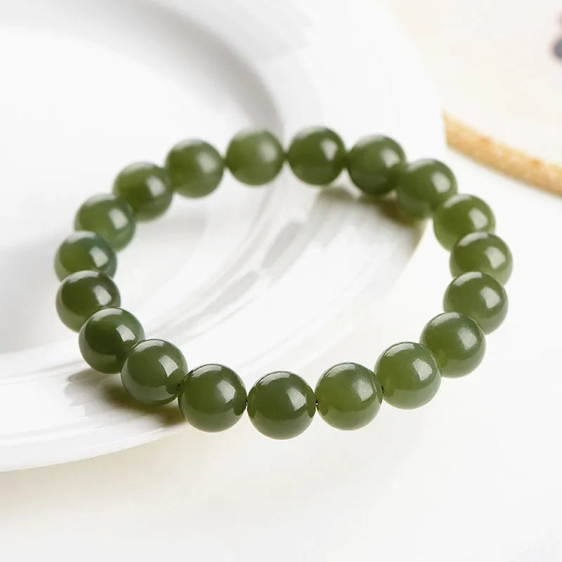 Polished Hetian jade beaded bracelet in ice-like clear water colour on a wrist.