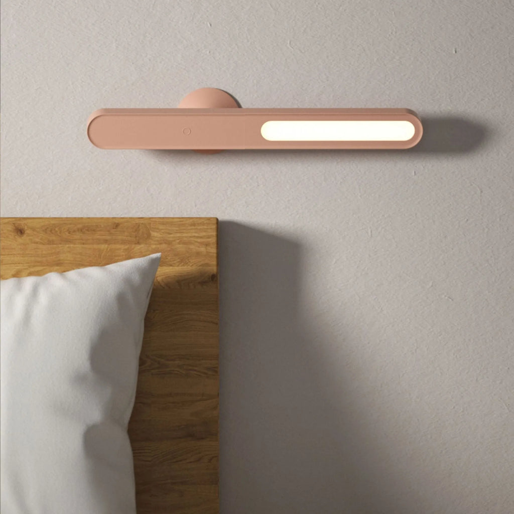 White geometric USB desk lamp with magnetic base shown on a wooden desk.