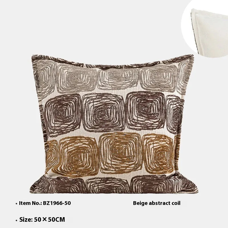 Cream and coffee coloured abstract coil pattern on two pillow sizes: a square cushion and a rectangular bolster.