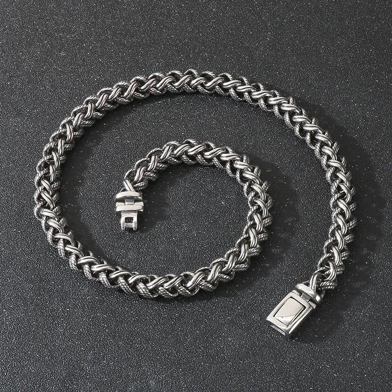 Men's antique silver titanium steel keel chain necklace with large hemp flower links on a grey background.