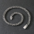 Men's antique silver titanium steel keel chain necklace with large hemp flower links on a grey background.