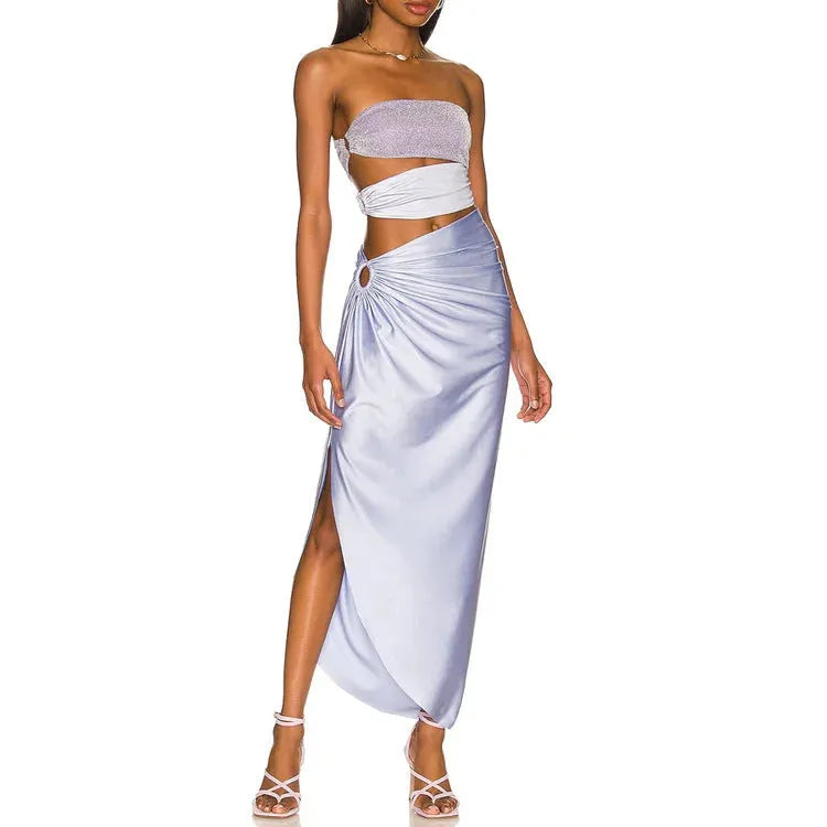 Purple one-piece swimsuit with coordinating wrap skirt set on beach background