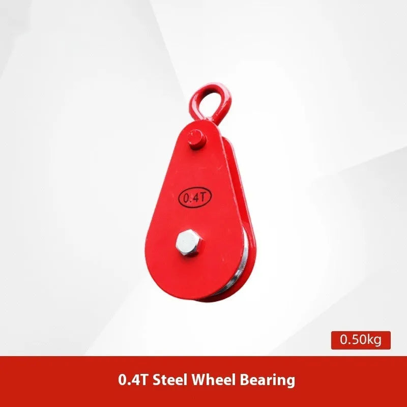 Red industrial steel lifting pulley with a safety latch on the hook.