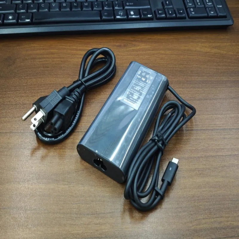 Black 65W Type-C laptop power adapter with multiple international power plugs