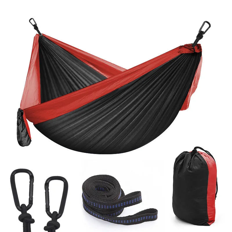 Double camping parachute hammock in 210T nylon black brown colour with tree straps and carabiners on outdoor setting