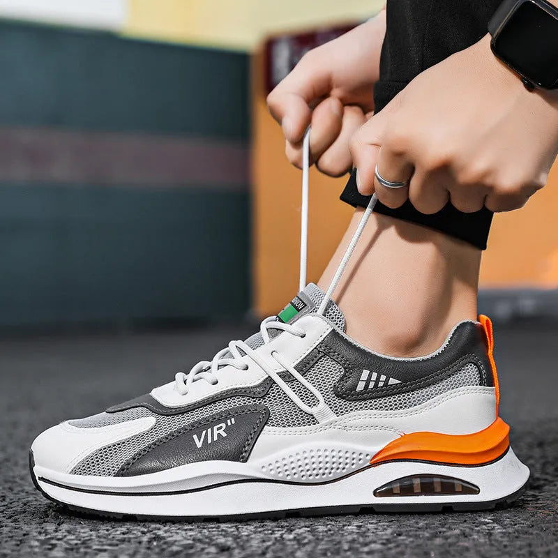 Men's gray breathable mesh running shoes with a round toe and casual sewing thread details on a white background.