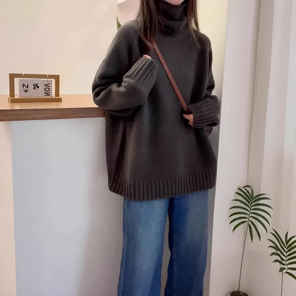 Red women's loose turtleneck sweater with a thick, textured curling pile collar.