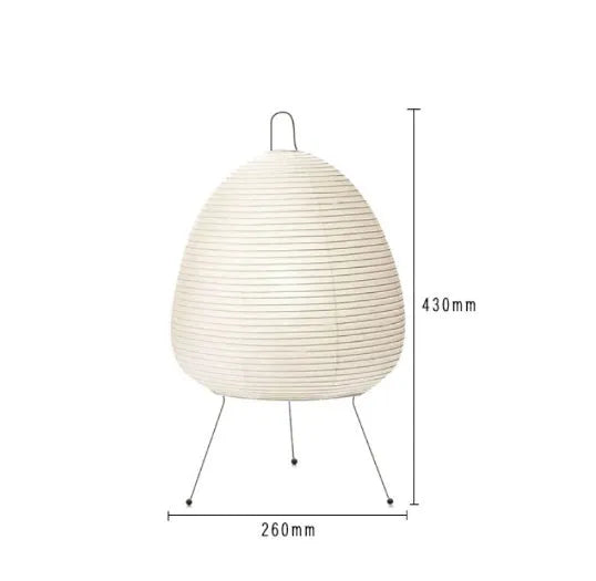 Japanese style rice paper table lamp with aluminium body and decorative shade on wooden surface