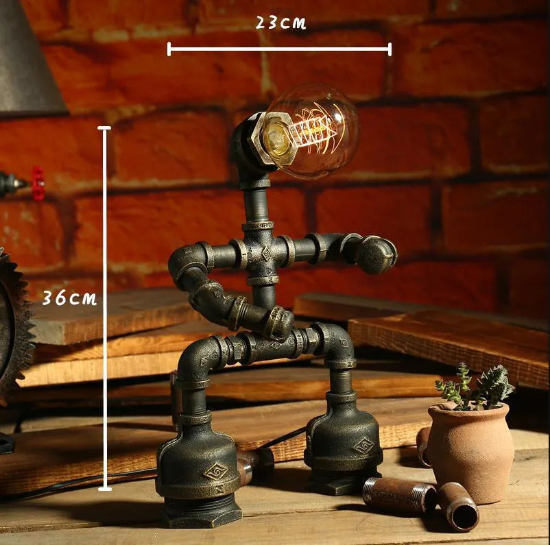 Green bronze vintage robot table lamp with industrial iron pipe design on wooden desk