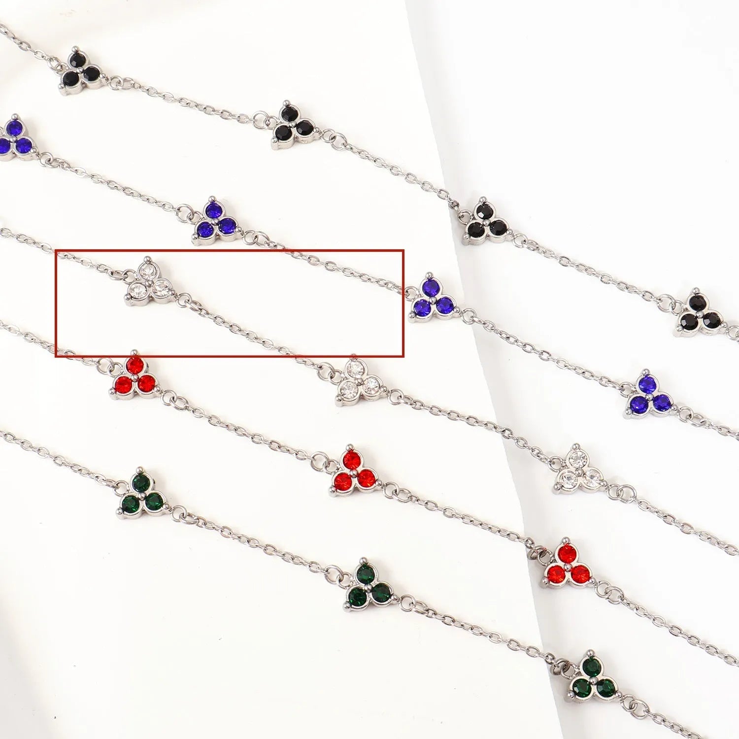 Stainless steel women's bracelet with three triangular diamond motifs set with colourful zircon stones.
