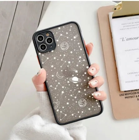 Black anti-blue-light soft-touch iPhone case for multiple models on a table.