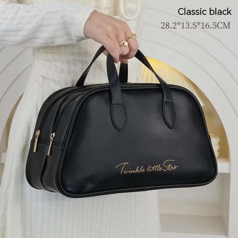 Leather travel toiletry bag in caramel mocha colour showing storage compartments and decorative letter details